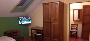 a room with a bedroom with a tv on the wall at Panorama in Cehu Silvaniei
