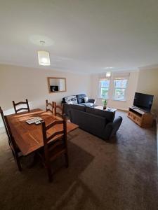 a living room with a couch and a table at The Elms Apartments Ramsey Isle of Man UK in Ramsey