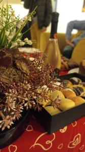 a box of cookies on a table with a bottle of wine at Palazzo Firenze in Naples