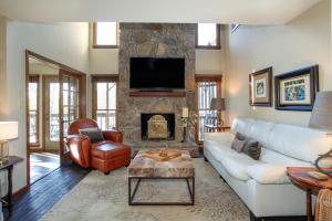 a living room with a couch and a fireplace at Misty Lake Hot Tub w Lake Access in Oak Ridge