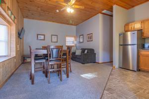 a kitchen and living room with a table and chairs at Stay In Ohiopyle - closest place to the GAP trail in Ohiopyle, PA in Farmington