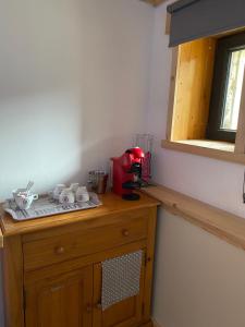 Chambre privée في آيم لا بْلانيِ: طاولة مطبخ مع جهاز احمر فوقها
