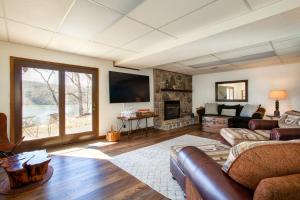 a living room with a couch and a fireplace at Misty Lake Hot Tub w Lake Access in Oak Ridge