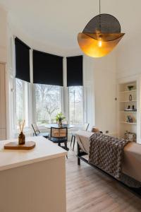 a living room with a couch and a table at The West End Retreat - Your Luxurious 5* Apartment in Glasgow