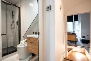 a bathroom with a toilet and a shower at The West End Retreat - Your Luxurious 5* Apartment in Glasgow