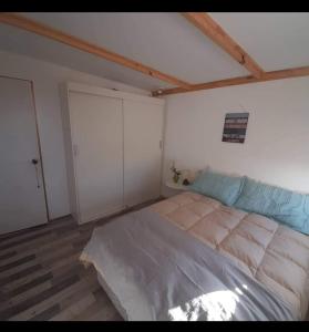 a bedroom with a large bed in a room at Loft a pasos de la playa in La Serena