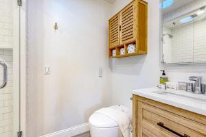 a bathroom with a toilet and a sink at Great Marsh House in Essex +18 photos