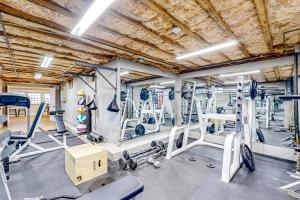 a gym with several treadmills and exercise equipment at Great Marsh House in Essex