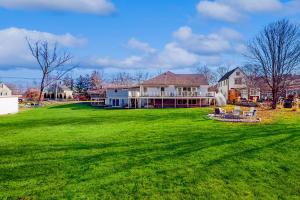 a large green yard with a large house at Great Marsh House in Essex