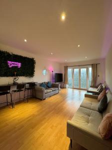 a living room with a couch and a table at Spacious Apartment with Balcony in Leicester