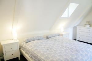 a bedroom with a bed and two night stands at Krabbe 32 in Tetenbüll