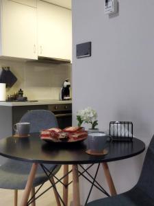 a table with a plate of food on it in a kitchen at Grey Sense Luxury Apartment in Heraklio