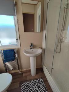 a small bathroom with a sink and a shower at LuaMar Holidays- Tattershall Lakes - Lancaster Crescent in Tattershall