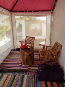 a room with two chairs and a table in a tent at Pinwheel Retreat in Lansdowne