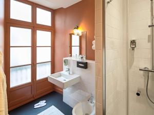 a bathroom with a sink and a shower at Mercure Nantes Centre Passage Pommeraye in Nantes