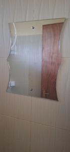 a mirror on a wall in a bathroom at Humble homes 1 bedroom Thika Cbd in Thika