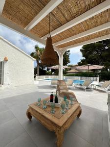 a patio with a table with wine glasses on it at Villa Casa Nella (familiale avec piscine privée) in Jávea