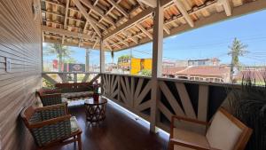 a balcony with chairs and a view of a city at Casa Sabor Chocolate Mar in Ubatuba +15 photos