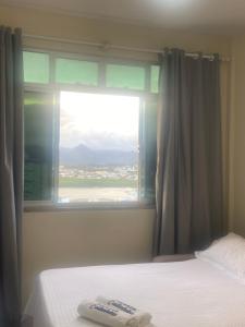 Ένα ή περισσότερα κρεβάτια σε δωμάτιο στο Kitnet