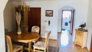 a dining room with a wooden table and chairs at Ferienwohnung Ruttner in Rastatt