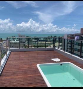 a balcony with a hot tub on top of a building at Vista mare InterMares in Cabedelo