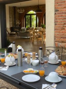 a table with plates of food on top of it at Chambres d hôtes La clé des arches in Sainte-Florine