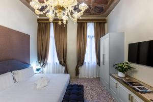 Postel nebo postele na pokoji v ubytování Hotel Palazzina Sardi