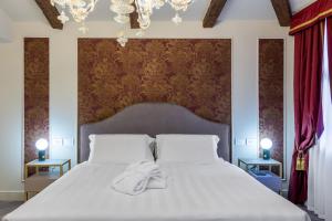 Postel nebo postele na pokoji v ubytování Hotel Palazzina Sardi