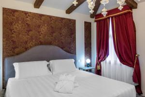 Postel nebo postele na pokoji v ubytování Hotel Palazzina Sardi