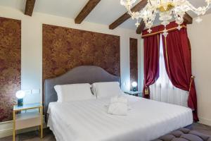 Postel nebo postele na pokoji v ubytování Hotel Palazzina Sardi