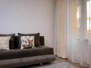 a couch with a deer pillow on it in a room at Квартира в тихом районе правого берега Астаны in Astana +18 photos