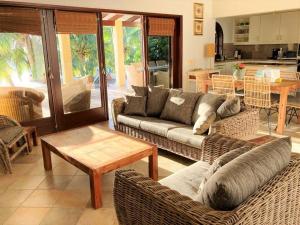 a living room with two couches and a table at Beach Villa Casa del Mar in Kralendijk