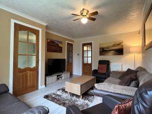 sala de estar con sofá y ventilador de techo en Spacious home near Glasgow Green, en Glasgow