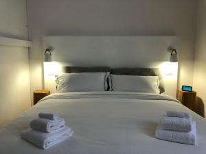 um quarto com uma cama branca com toalhas em Art Apartments em Florença