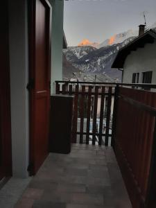 a door to a balcony with a view of a mountain at CIVICO 43/B in Chiesa in Valmalenco