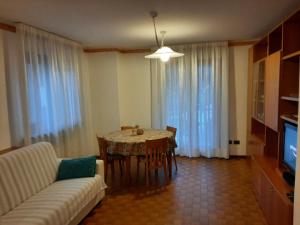 a living room with a table and a couch at CIVICO 43/B in Chiesa in Valmalenco