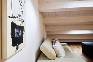 a living room with a couch and a painting on the wall at Loft del Faro in Fano