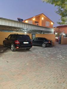 dos autos estacionados en un estacionamiento frente a una casa en Hotel Sabi en Maminas