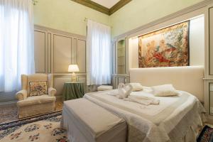 a bedroom with two beds and a painting on the wall at Fortuny 3967 Luxury suites wine in Venice