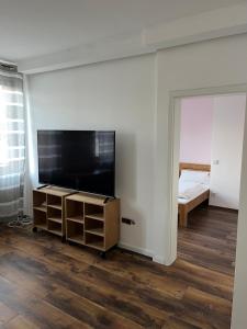 a room with a flat screen tv and a bedroom at Wohnungen bei Post in Hünfelden