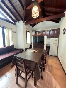 a kitchen and dining room with a table and a couch at Complejo Aires 1 in San Bernardo