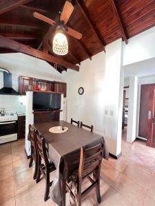 a kitchen with a table and chairs and a ceiling fan at Complejo Aires 1 in San Bernardo