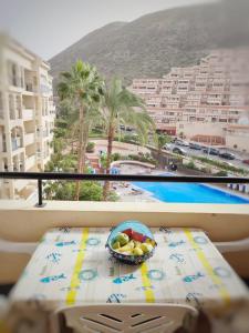 a bowl of fruit sitting on a table on a balcony at Castle Margherita's Apartments in Los Cristianos
