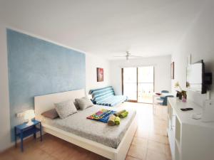 a living room with a bed and a couch at Castle Margherita's Apartments in Los Cristianos