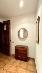 um quarto com um espelho e uma cómoda em madeira em Cozy Ploblesec Apartment em Barcelona