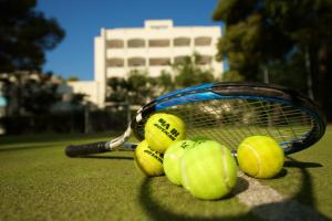 a group of tennis balls and a racket on a court at Hotel Portonuovo in Vieste