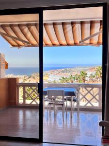 a dining room with a table and a view of the ocean at FANTASTIC PARADISE with WiFi in Adeje