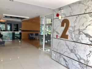a lobby with a marble wall with the number on it at Easy Easy2 @ The blu x in Ban Bang Saen (1)