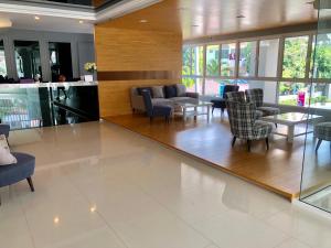 a lobby with chairs and tables in a building at Easy Easy2 @ The blu x in Ban Bang Saen (1)