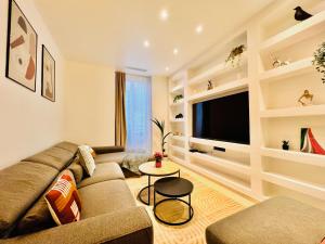 a living room with a couch and a tv at Apartment Malaussena - Reception 24&7 - Center Libération in Nice